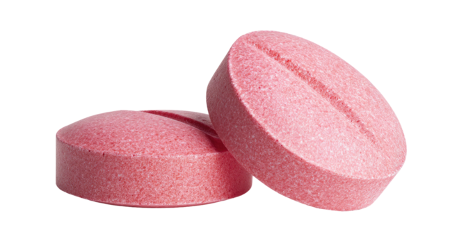 Two pink pills on a white background