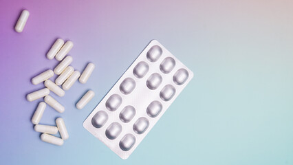 Colorful pills scattered with a blister pack on a vibrant background showcasing health and wellness