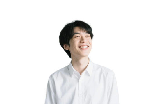 A young man in a white shirt is smiling, presenting a positive and pleasant appearance.