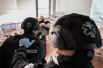 Paramedics evaluating patient lying on chair during emergency operation