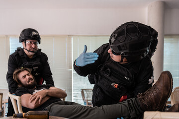 Paramedics evacuating injured man from dangerous situation