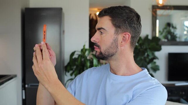 Pretentious man using his mobile phone as a mirror 