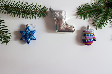 Christmas decorations and fir tree branches on a white background. Copy space.