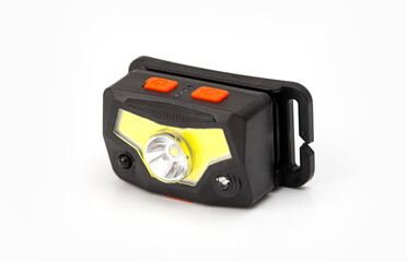 Black headlamp with orange buttons isolated on a white background.