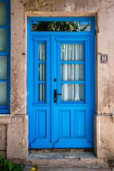 Colorful decorative doors of old houses in the streets of Ayvalik city center. Ayvalik - Turkey
