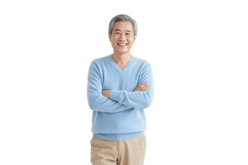 An elderly man in a light blue sweater stands with arms crossed, smiling in a simple background.