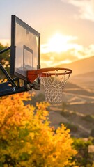 Basketball hoop set against a vibrant sunset over rolling hills