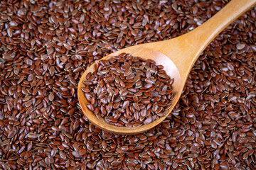 Pile of flax seeds isolated on white background close-up, top view
