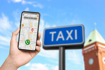 Man using app on mobile phone to call taxi on city street, closeup