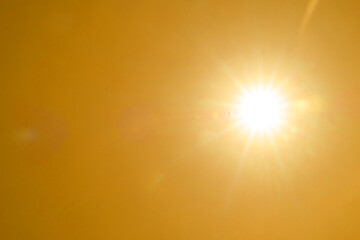 Obraz premium Bright sun in orange sky during hot summer weather. Extremely high temperature