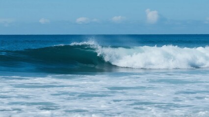 Fototapeta premium A stunning ocean wave is seen rolling in, with clear blue sky in the background, showcasing the beauty of the sea.