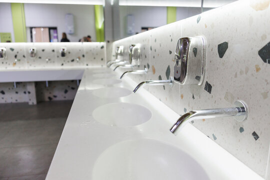 Modern Public Restroom Sinks with Wall-Mounted Faucets and Terrazzo Counter