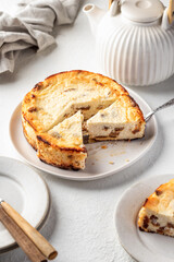 Homemade cottage cheese casserole pie with raisins. Baked cheesecake for healthy breakfast on white table background