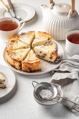 Homemade cottage cheese casserole pie with raisins. Baked cheesecake for healthy breakfast on white table background