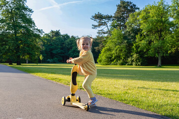 Scooter outdoor. Child play park nature. Toddler balance wheels road.