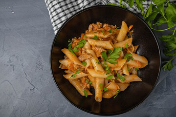 Penne pasta with meat and seasonings on a plate