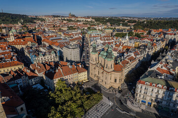 Beautiful view of St. Nicholas Church in Prague’s Old Town Square, surrounded by historic buildings and vibrant city life in the heart of the Czech capital.