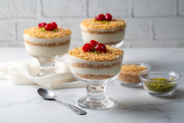 Traditional milky crispy Ramadan dessert custard pudding with roasted kadayif and diced pistachio . Kadayifi Muhallebi