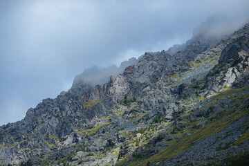 Majestic mountain landscape with rocky peaks and misty clouds