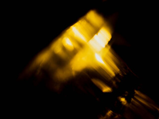 Yellow and orange light leaks on dark color background. Abstract light shape and form. Background for design and special effects.