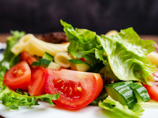 Meal with two tasty burgers, pasta and fresh salad and no sauce. Diet dinner for people with high blood sugar. Healthy food.