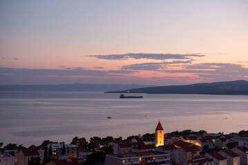 Dusk over coastal town and bell tower