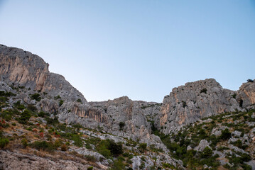 Fototapeta premium Limestone cliff with scrub in the evening