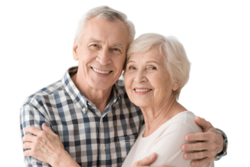An elderly couple is seen embracing with bright smiles against a plain white background, showing a sense of warmth and affection.