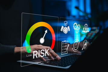 Risk assessment and management concept. Person using laptop with rising risk meter and digital icons, symbolizing business risk analysis, compliance, warning systems and decision-making support tools.