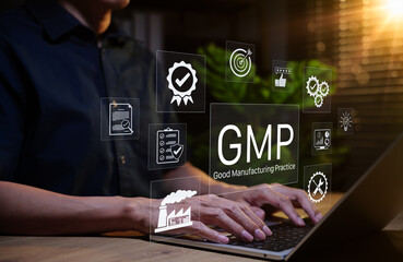 Good Manufacturing Practice (GMP) Concept. Businessman working on laptop with icons representing compliance, quality control, assurance, certification, factory standards, certified process management,
