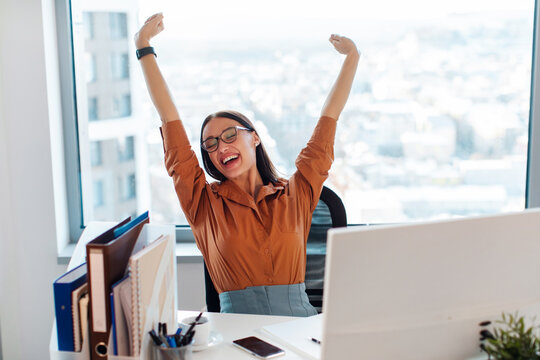 Satisfied businesswoman stretching at workplace after finished work project, sitting at workplace, female employee relaxing during break, breathing deep, feeling no stress