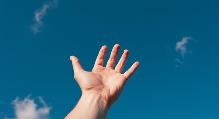 Hand Reaching Up Towards a Vibrant Blue Sky