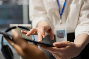 Close up of data center engineering team using tablet to inspect gear, doing maintenance tasks....
