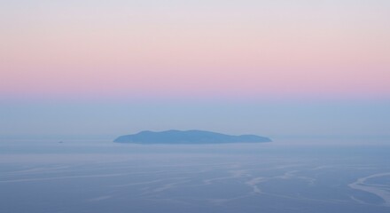 Obraz premium Misty Island Sunrise Over Calm Sea