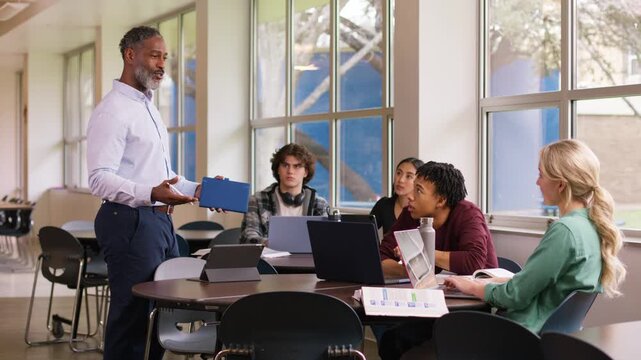 Classroom scene of a teacher engaging with a diverse group of students during a lesson.