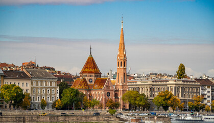 Orange colors in Szil&aacute;gyi Dezső Square Reformed Church from the other side of the Danube River in Budapest