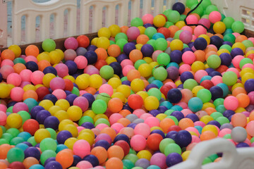 colorful plastic balls in a ball pit the balls are of various colors including red blue green yellow and purple	
