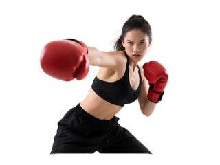 A young woman in boxing gloves is in a boxing pose, demonstrating strength and focus in her workout.