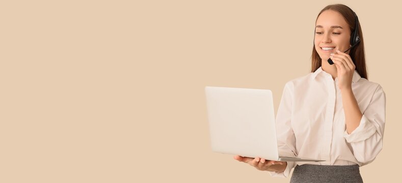 Female business speaker in headset and with laptop on beige background with space for text
