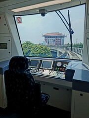 Train driver cabin with control panels and forward track view