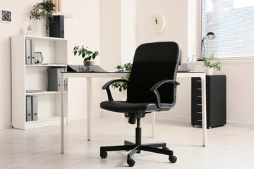 Leather black office chair in interior of room, closeup