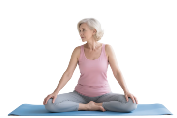 A senior woman is doing yoga in a meditative pose, promoting health and relaxation.