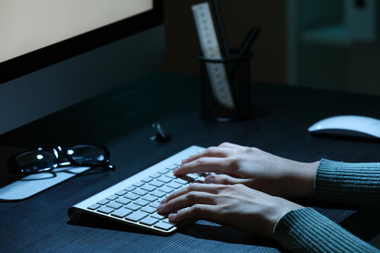 Professional programmer working with modern computer at table in office, closeup