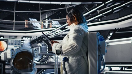 Fototapeta premium Astronaut inside high tech spacecraft checking red planet summary analytics during routine mission check. Orbit station cosmonaut using device, standing near monitor showing Mars data