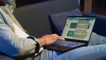 African american expert closing monthly revenue balance on web platform, working remotely on...