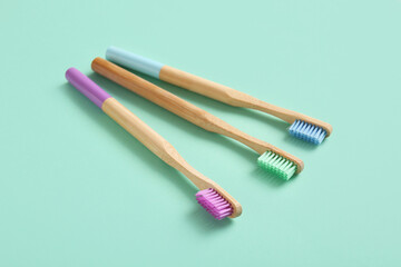 Composition with wooden toothbrushes on turquoise background, closeup