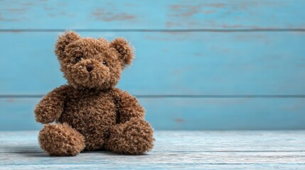 Adorable Brown Teddy Bear Sitting on a Blue Wooden Surface, Ideal for Childhood and Comfort Concepts