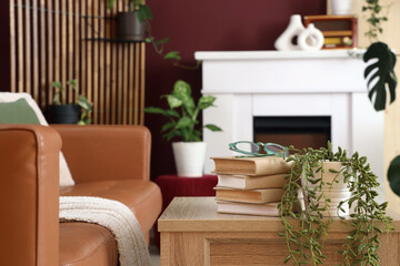 Interior of stylish living room with cozy brown sofa, wooden coffee table and fireplace