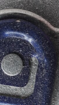 Extreme Close Up (Macro) Of A Dusty Blue Aluminum Soda Or Beer Can Pull Tab Slowly Rotating. Beverage Container Detail. Vertical