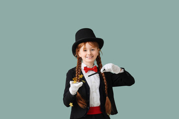 Young magician showing magic trick with stars on green background